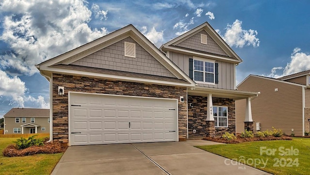 craftsman-style house with a front yard and a garage