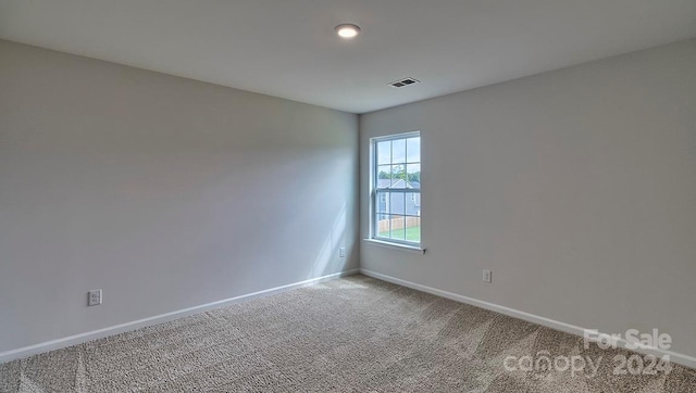 empty room featuring light colored carpet