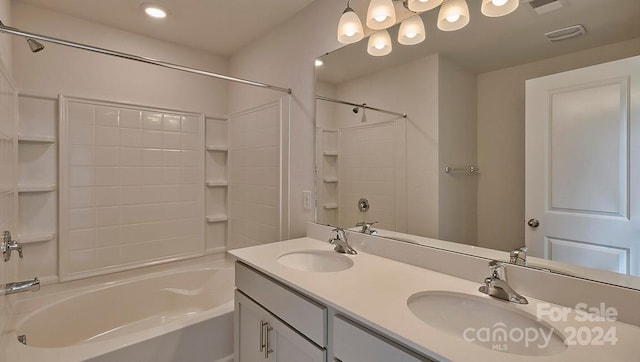 bathroom with shower / washtub combination and dual vanity