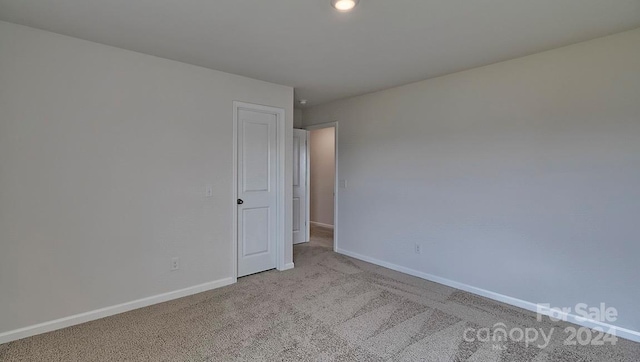 spare room with light colored carpet