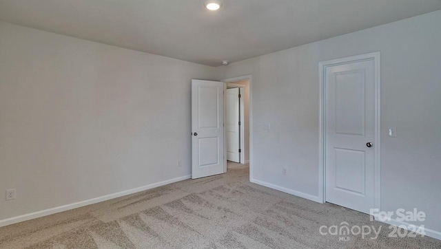 unfurnished bedroom featuring light colored carpet