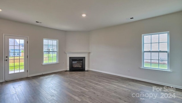 unfurnished living room featuring dark hardwood / wood-style flooring