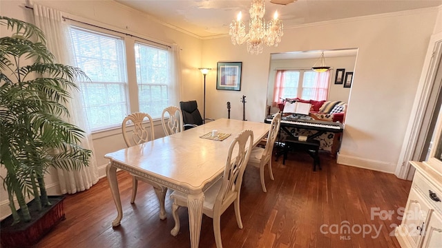 dining space featuring crown molding, an inviting chandelier, dark hardwood / wood-style floors, and plenty of natural light