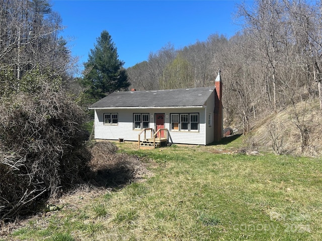 rear view of house with a lawn