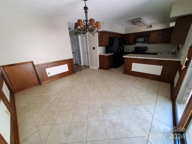 kitchen featuring an inviting chandelier, sink, black appliances, light tile patterned flooring, and dark brown cabinetry