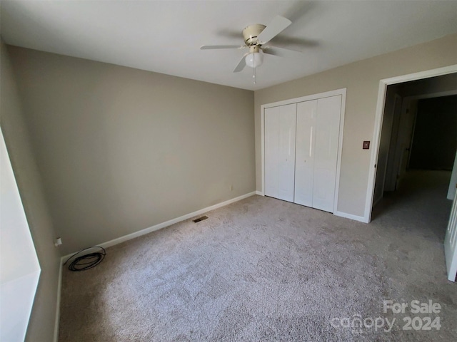 unfurnished bedroom featuring a closet, ceiling fan, and carpet floors