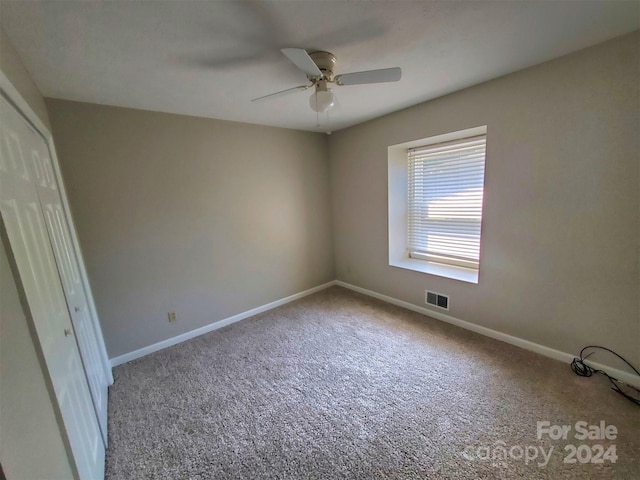 unfurnished bedroom with carpet flooring, a closet, and ceiling fan