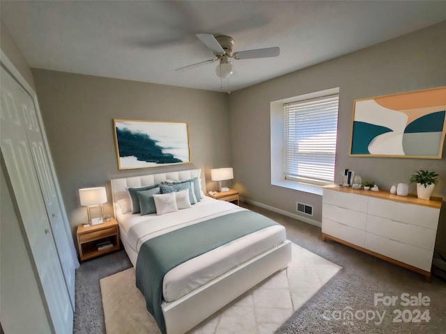 bedroom with a closet, ceiling fan, and carpet