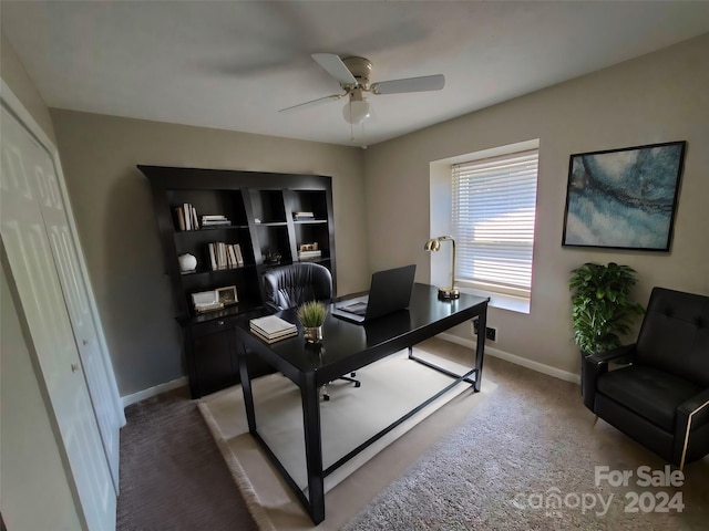 carpeted office space featuring ceiling fan