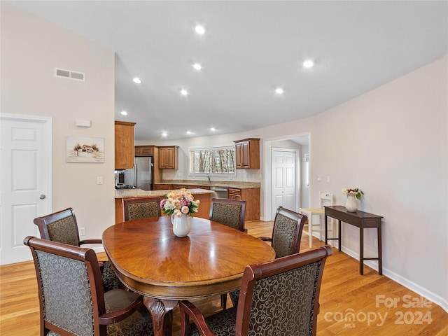 dining space featuring light wood-type flooring