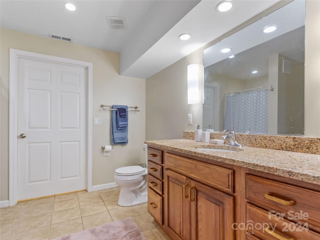 bathroom with toilet, tile flooring, and oversized vanity