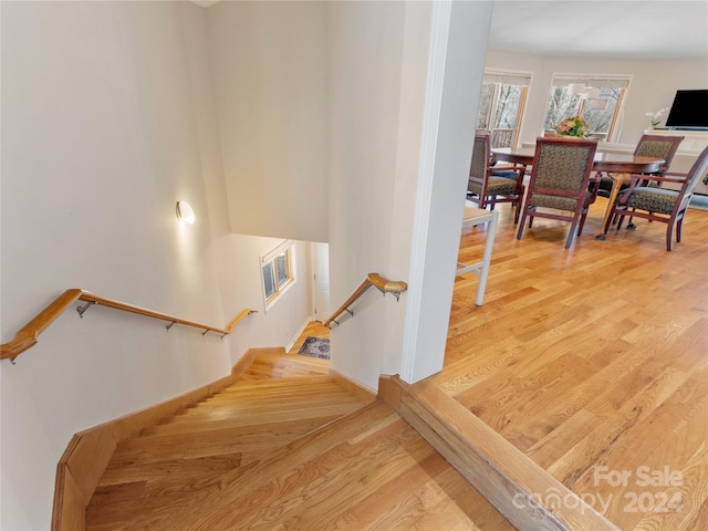 stairs featuring light hardwood / wood-style floors