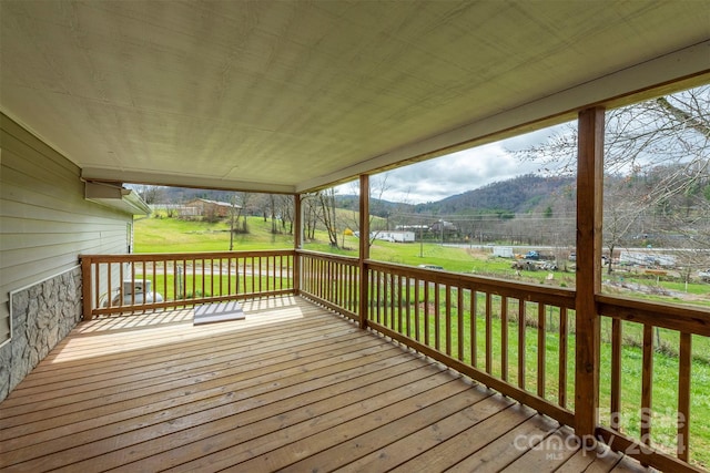 wooden deck featuring a yard