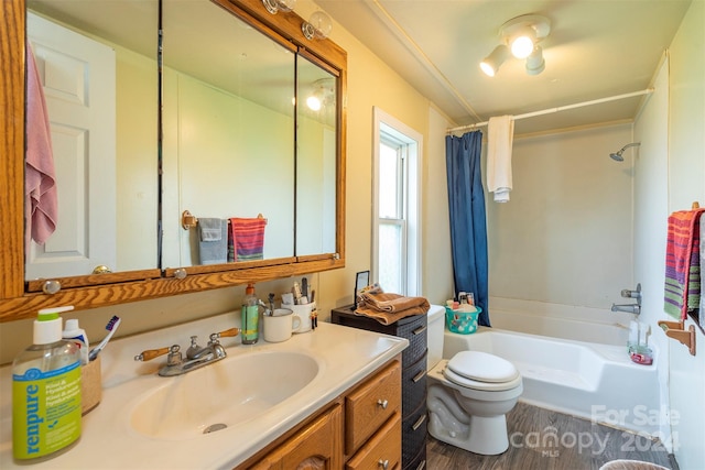 full bathroom featuring toilet, vanity, hardwood / wood-style flooring, and shower / tub combo