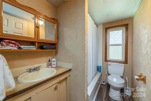 full bathroom with hardwood / wood-style flooring, toilet, shower / bathing tub combination, and vanity