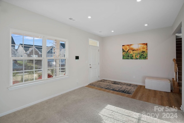 entrance foyer with plenty of natural light and hardwood / wood-style floors