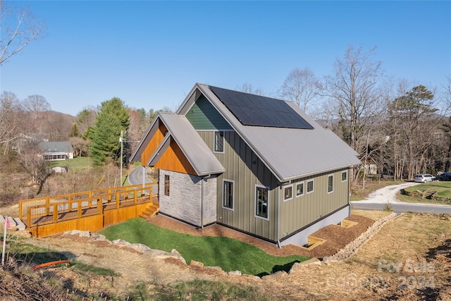 view of side of home with solar panels