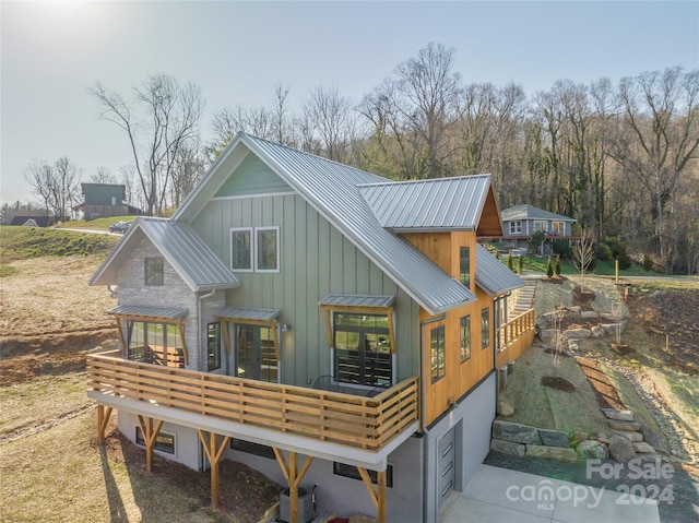 rear view of house featuring a deck