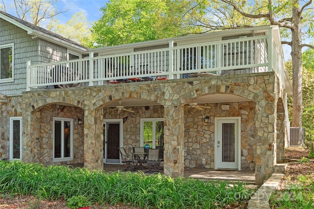 view of front of property featuring a patio area and a balcony