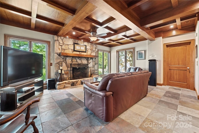 tiled living room with ceiling fan, beam ceiling, coffered ceiling, wooden ceiling, and a fireplace