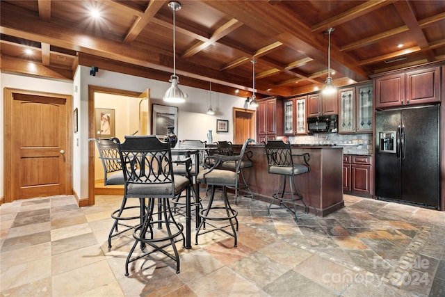 kitchen featuring a kitchen breakfast bar, tasteful backsplash, black appliances, and coffered ceiling