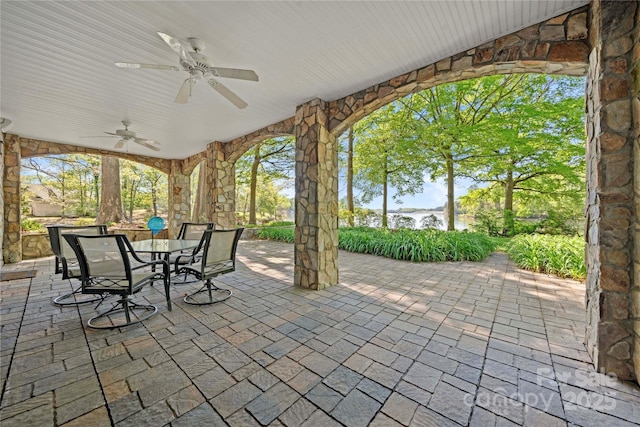 view of patio with outdoor dining space and a ceiling fan