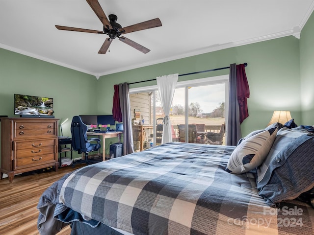 bedroom with dark wood-type flooring, ceiling fan, and ornamental molding