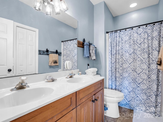 bathroom with tile floors, double sink, toilet, a chandelier, and vanity with extensive cabinet space