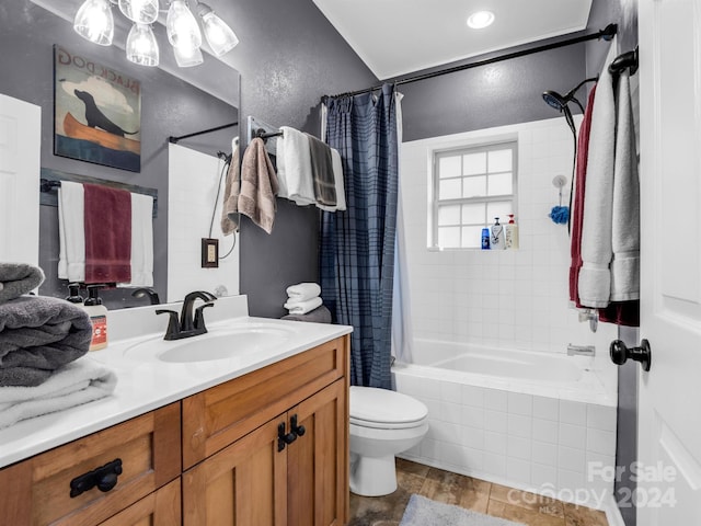 full bathroom featuring toilet, tile floors, vanity, and shower / bath combo