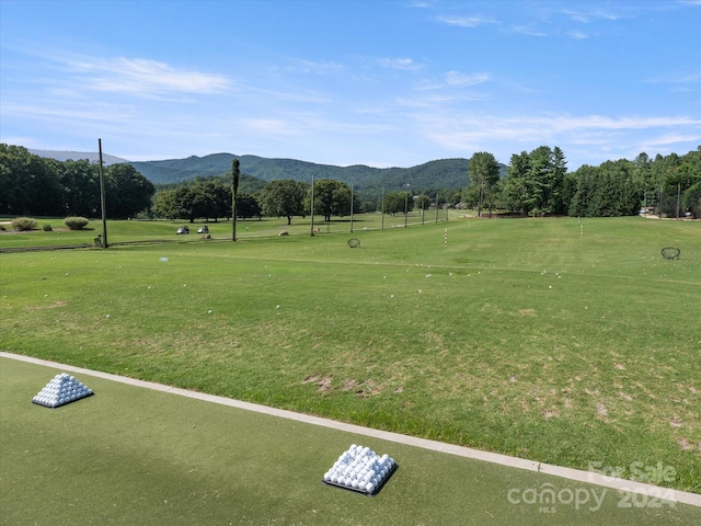 view of home's community with a mountain view and a yard