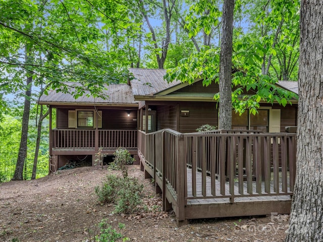 rear view of property featuring a deck