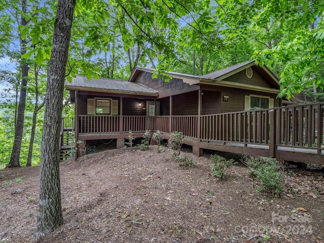 rear view of house with a wooden deck