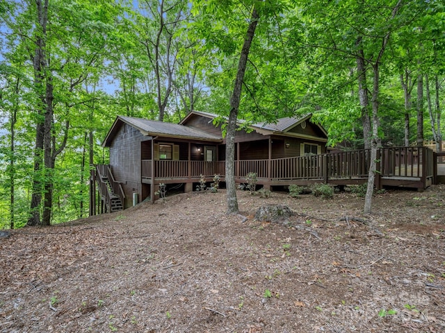 rear view of house featuring a deck