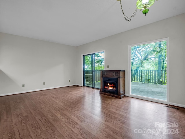 unfurnished living room with dark hardwood / wood-style flooring