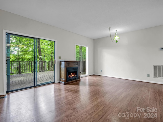 unfurnished living room with dark wood-type flooring