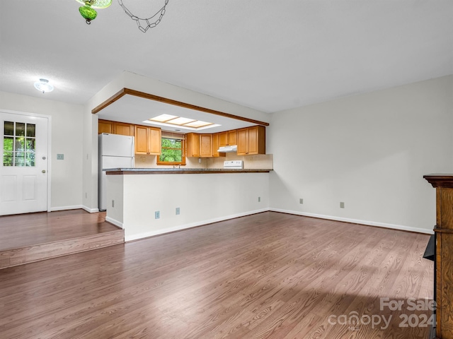 unfurnished living room featuring wood-type flooring and plenty of natural light