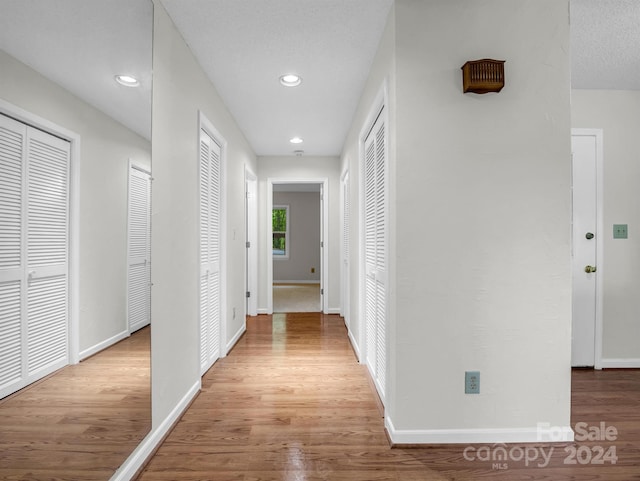 corridor with light hardwood / wood-style flooring