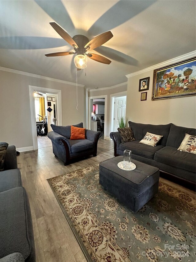 living room featuring crown molding, ceiling fan, and hardwood / wood-style floors