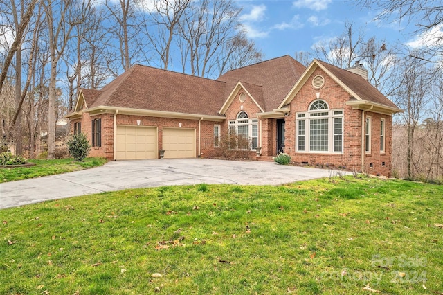 view of front of house with a front lawn and a garage