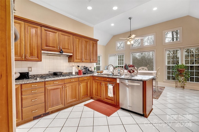 kitchen featuring ceiling fan, light tile floors, light stone counters, stainless steel appliances, and tasteful backsplash