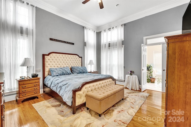 bedroom with ceiling fan, crown molding, and light hardwood / wood-style flooring