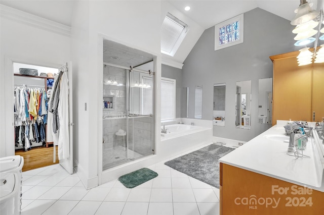 bathroom with plus walk in shower, ornamental molding, tile floors, vaulted ceiling, and vanity