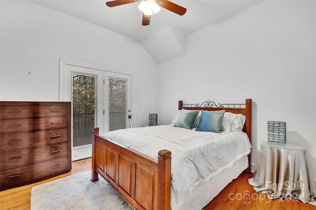 bedroom featuring light hardwood / wood-style flooring, ceiling fan, access to outside, and vaulted ceiling