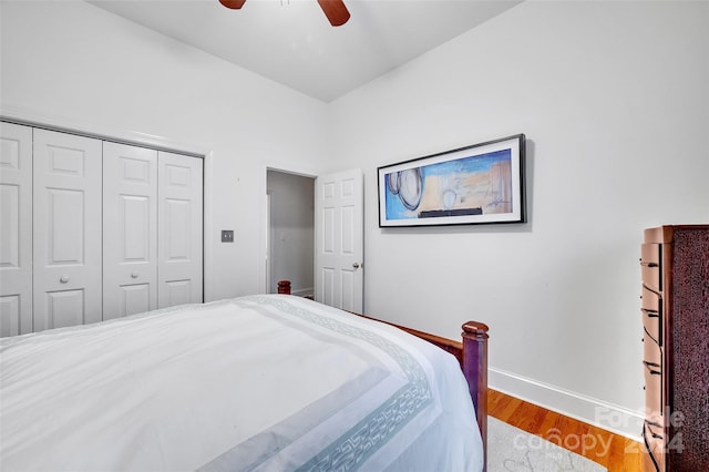 bedroom featuring ceiling fan, a closet, and hardwood / wood-style flooring