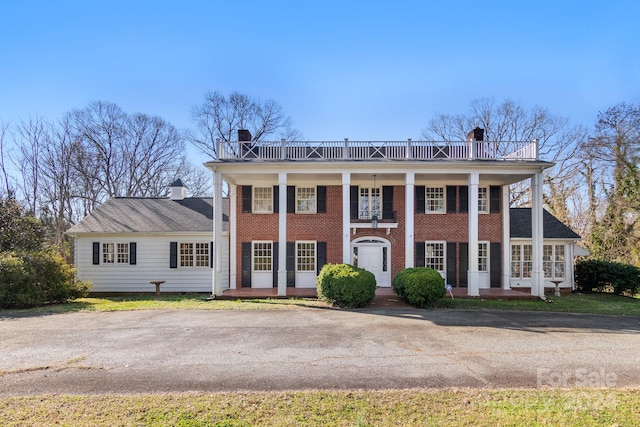 greek revival house with a balcony