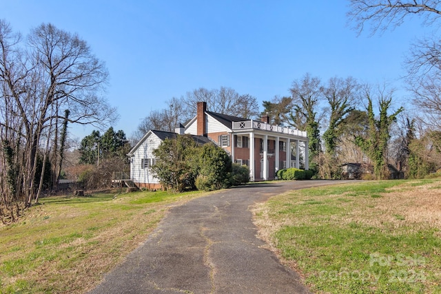 neoclassical / greek revival house with a front yard