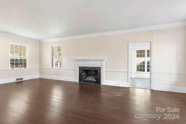 unfurnished living room featuring ornamental molding, a high end fireplace, and dark hardwood / wood-style flooring