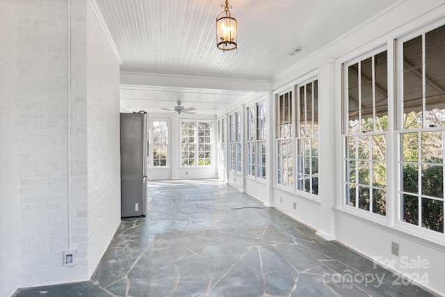 unfurnished sunroom featuring ceiling fan