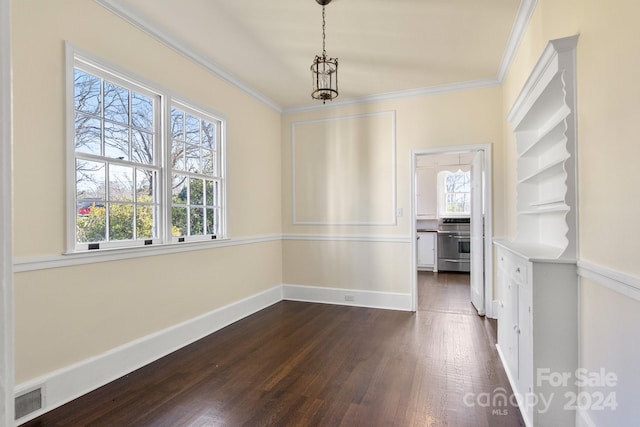 unfurnished room with plenty of natural light, crown molding, and dark hardwood / wood-style floors