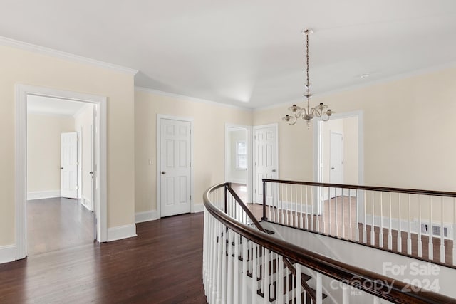 hallway featuring dark hardwood / wood-style flooring, a notable chandelier, and ornamental molding